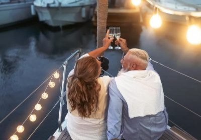 senior-couple-toasting-champagne-on-sailboat-vacat-2024-11-27-11-28-33-utc